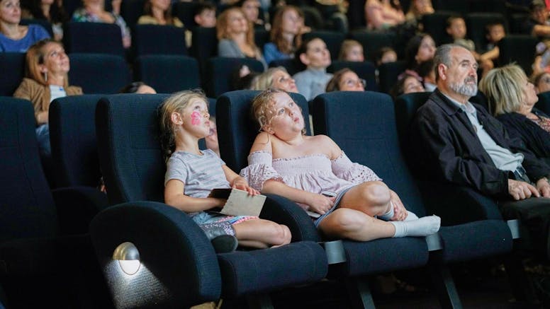 two children in a theatre audience